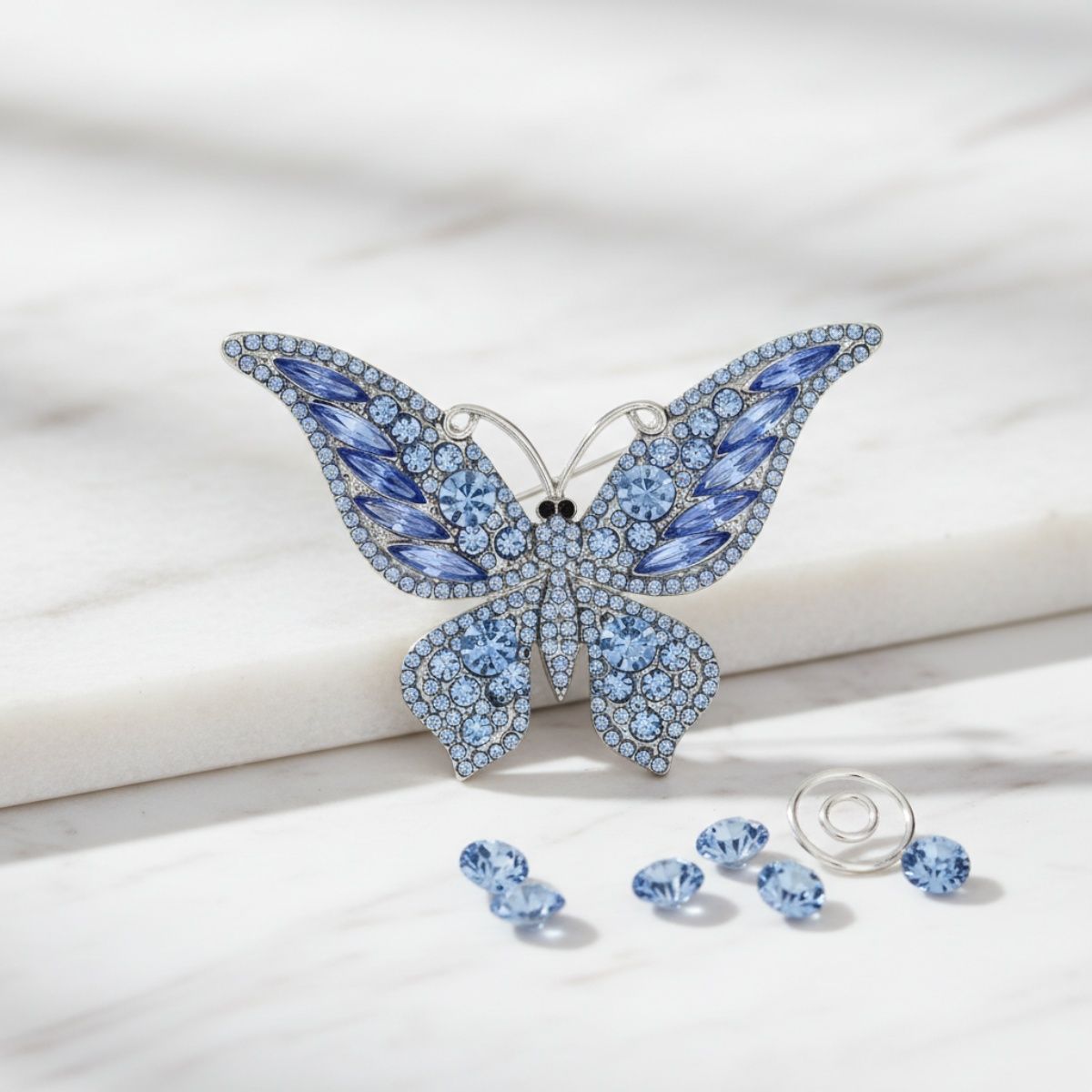 Silver Butterfly Brooch with Light Blue Stone – Stylish Statement Jewelry Accessory
